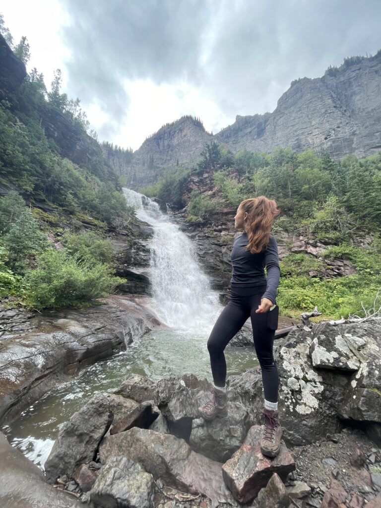 Beautiful Instagram model near a waterfall in Telluride, CO