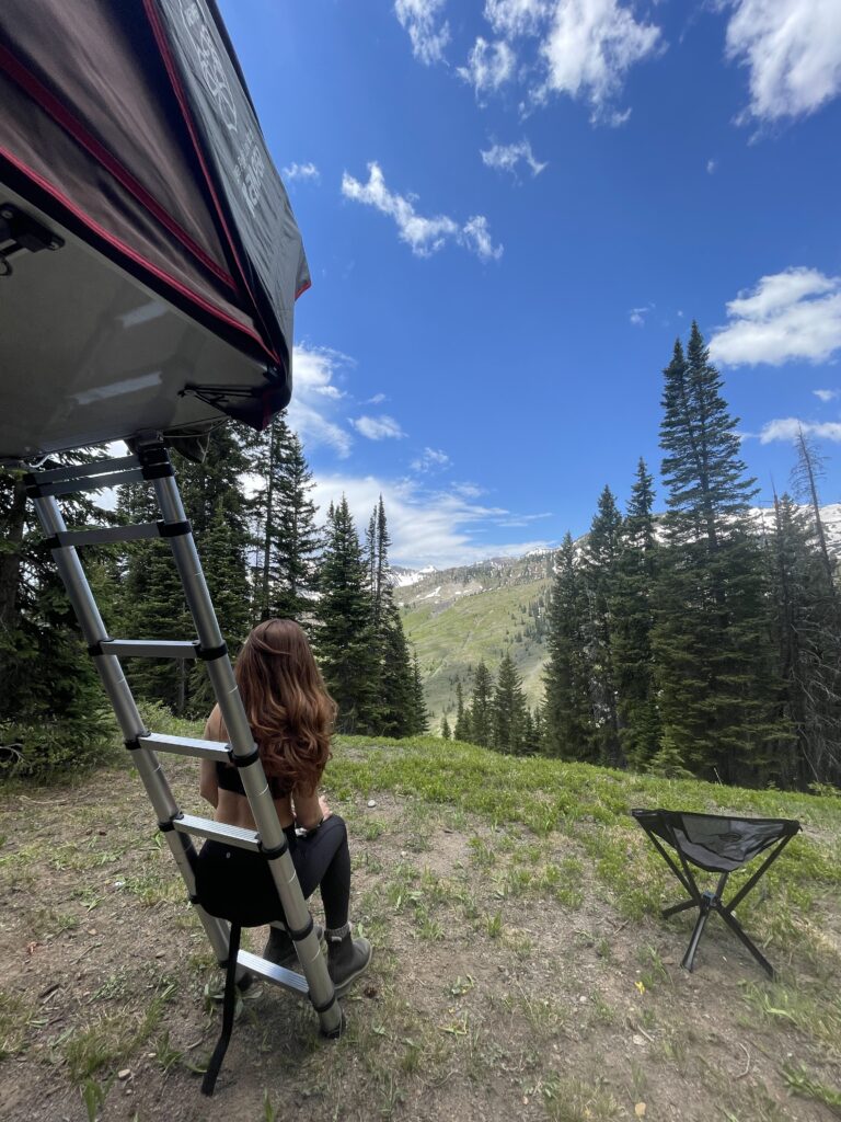 Beautiful woman enjoying her rooftop tent