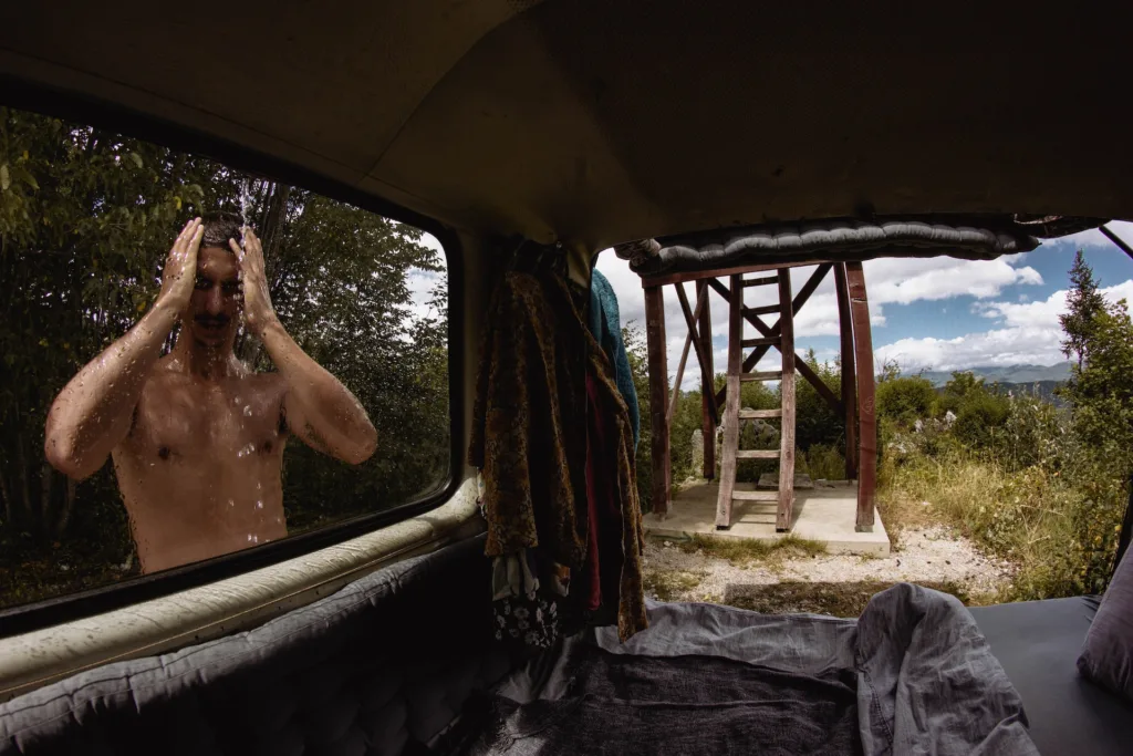 man taking a camping shower