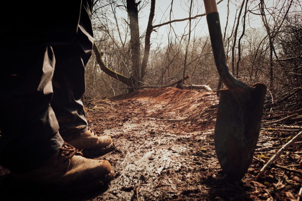 Man with a shovel in the woods